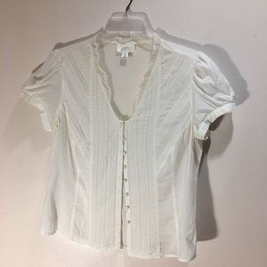 A delicate white short sleeve shirt with ruffles